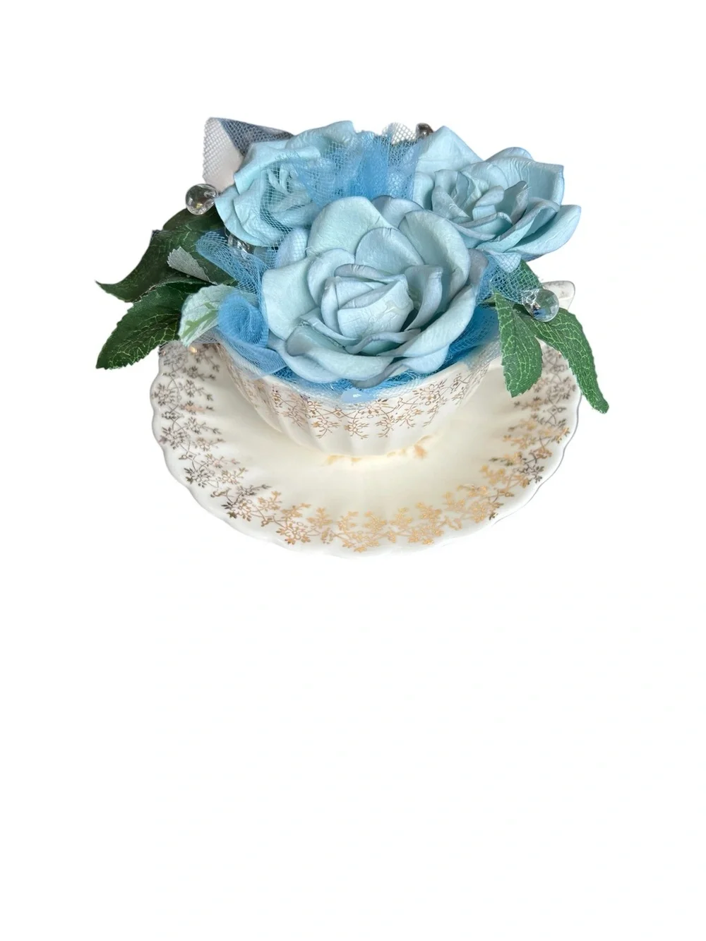 American Limoges vintage Teacup and saucer with blue artificial flowers.